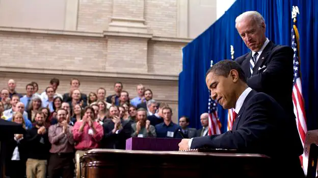 President Obama signs a bill in Denver, February 2009.